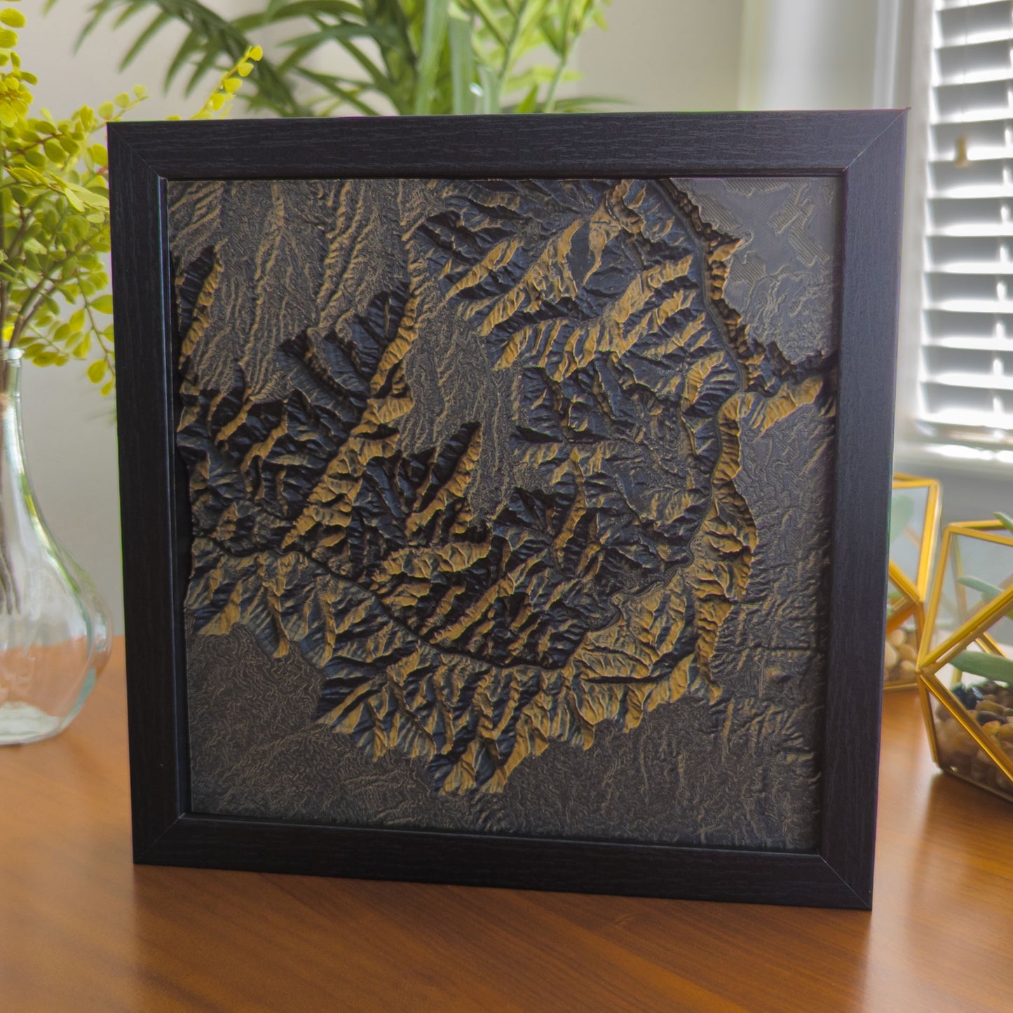 3D topographical print of a section of the Grand Canyon, in rusted steel with black shadowbox frame